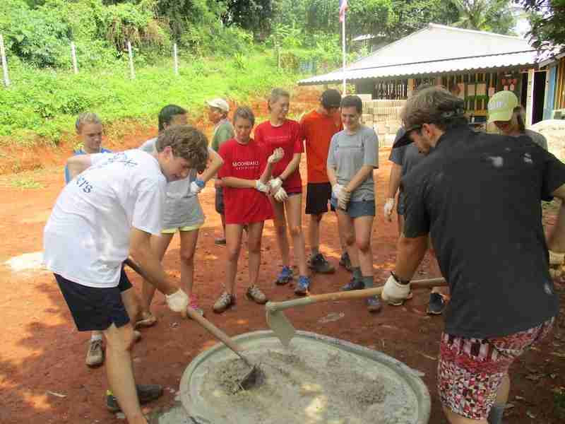 Young people mixing concrete