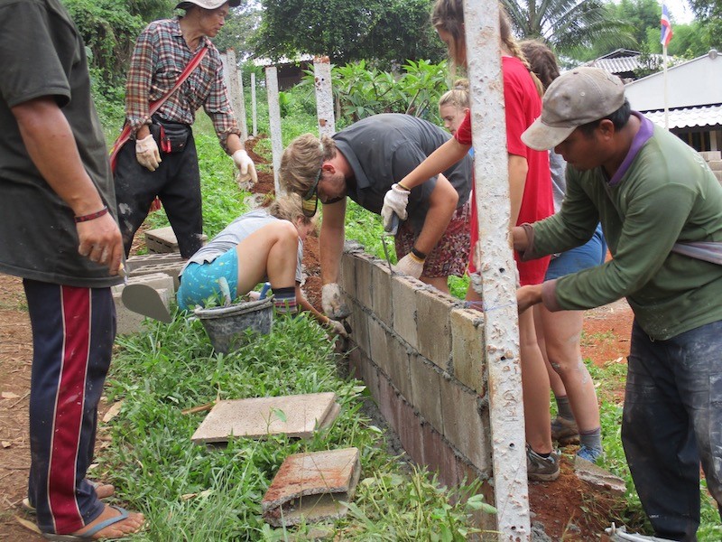 People constructing a wall