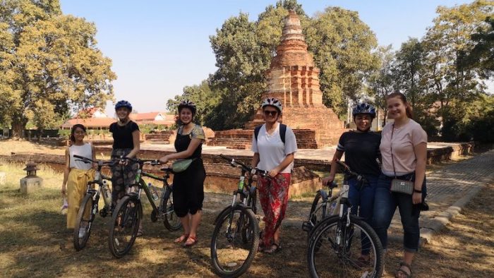 Cyclist in front of ruin Chiang Mai Thailand educational tour