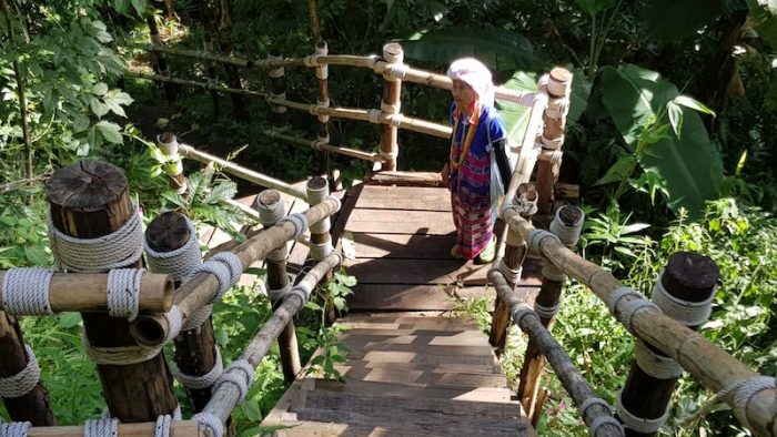 woman in traditional dress on staircase Pha Dok Siew Trail